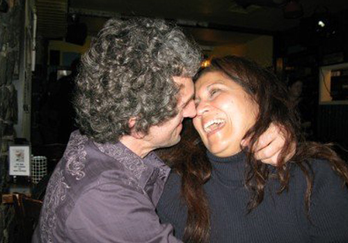 This is an image of Tommy & Saundra O'Sullivan embracing and laughing.